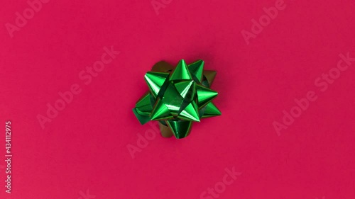 Unwrapping gift revealing a green screen - Stop Motion Animation - Green bow on a red background
