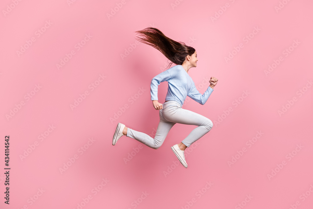 Full length body size view of nice motivated cheerful girl jumping running fast movement isolated over pink pastel color background