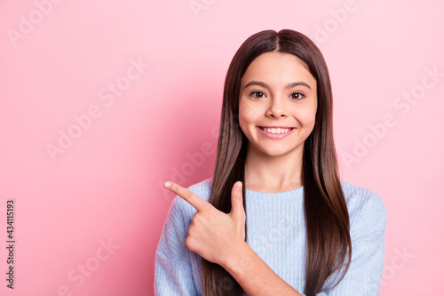 Portrait of attractive confident cheerful girl demonstrating copy space look idea decision isolated over pink pastel color background