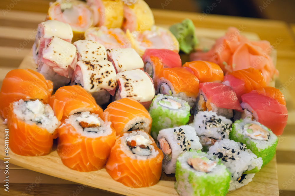 Assorted rolls are laid out on the board. Japanese cuisine Assorted rolls are laid out on the board. Japanese cuisine
