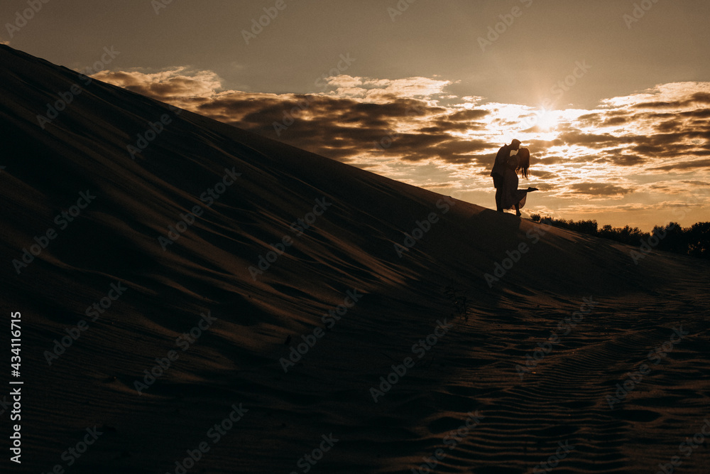 love couple activity sandy desert sunset reflection