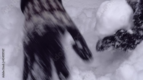 Close up of hands making a ball from snow. Wearing woven gloves with nordic pattern. Snow shaping video. High quality audio recording. ASMR style video and audio.