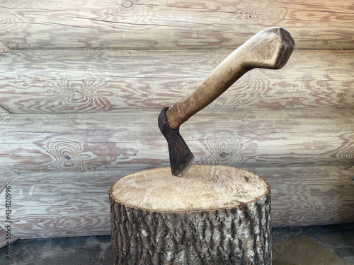 axe with a wooden handle in the stump for chopping wood
