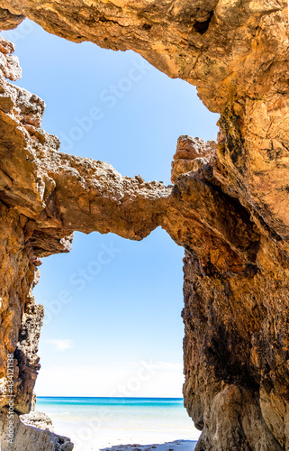 A window in rock formation on the beach in Algarve, Portugal