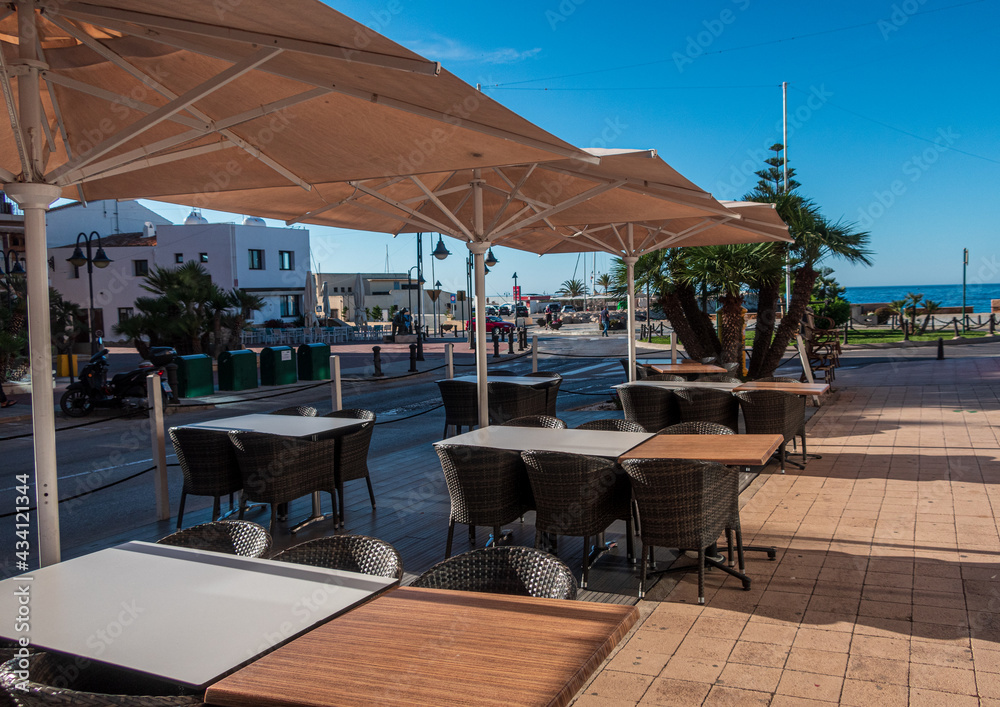 Fototapeta premium Empty tables and chairs in a bar in Moraira, Alicante (Spain).
