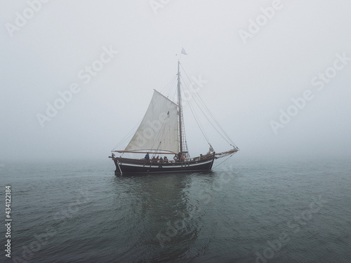 Ship sailing in the sea on a foggy day