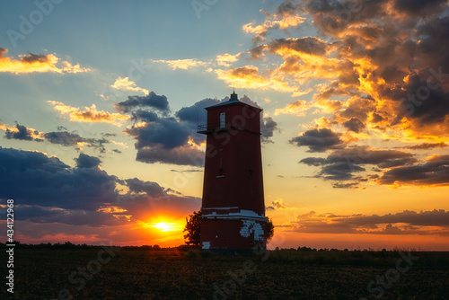 фотографія Khablovskiy lighthouse standing in the field at sunset, scenic landscape