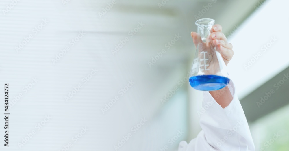 Composition of female scientist in lab holding flask with fluid with motion blur Composition of female scientist in lab holding flask with fluid with motion blur