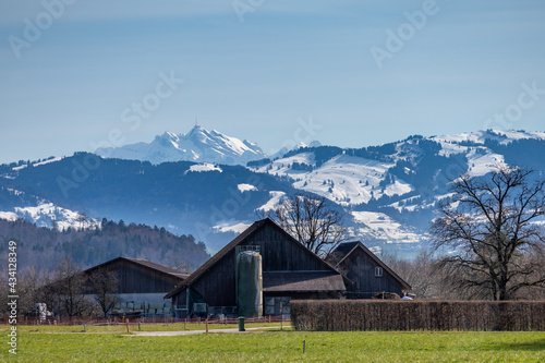 Rural scenes in the canton of St. Gallen with the imposing, snow covered Santis Peak in the bacground, Switzerland
