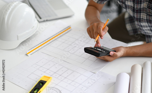 Architects are using a calculator to estimate the cost of house plans.