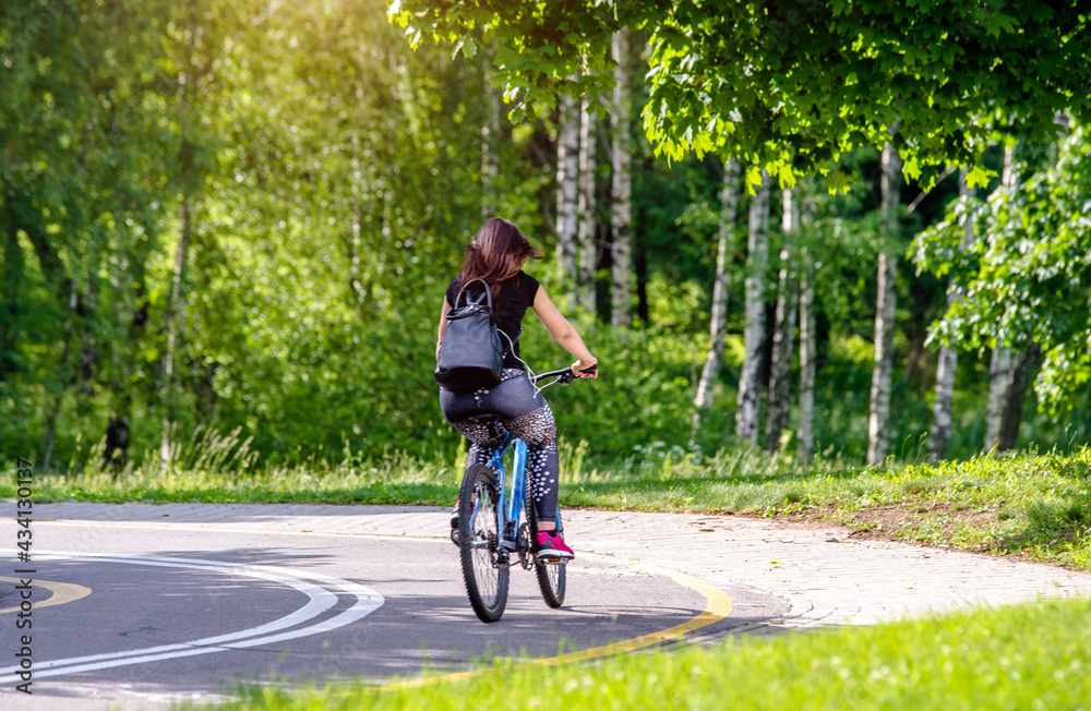 Cyclist ride on the bike path in the city Park
