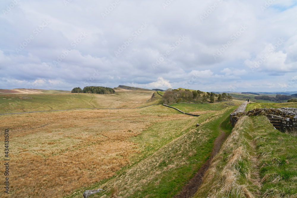 The remains of Hadrians Wall under a grey sky in Northumbria
