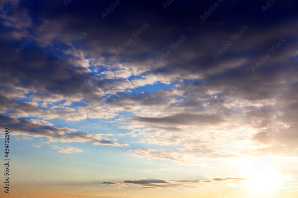 Stratocumulus clouds in the twilight . Cloudy atmosphere with sunlight