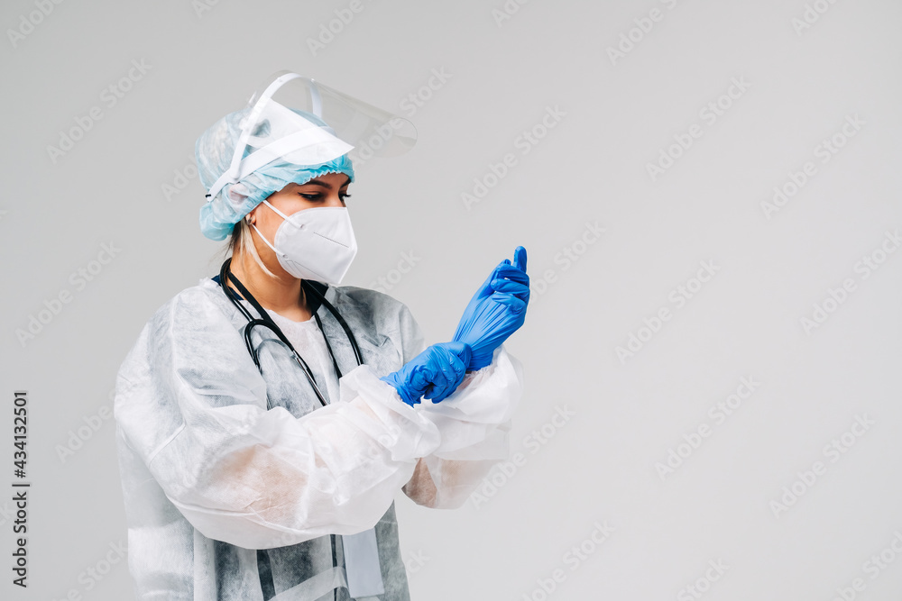 Young woman nurse hospital worker in medical protective mask, gloves and protective wear isolated on white background with copy space. Young woman nurse hospital worker in medical protective mask, gloves and protective wear isolated on white background with copy space.