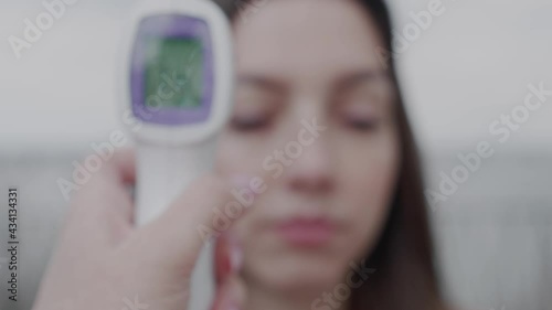 temperature check with digital thermometer.