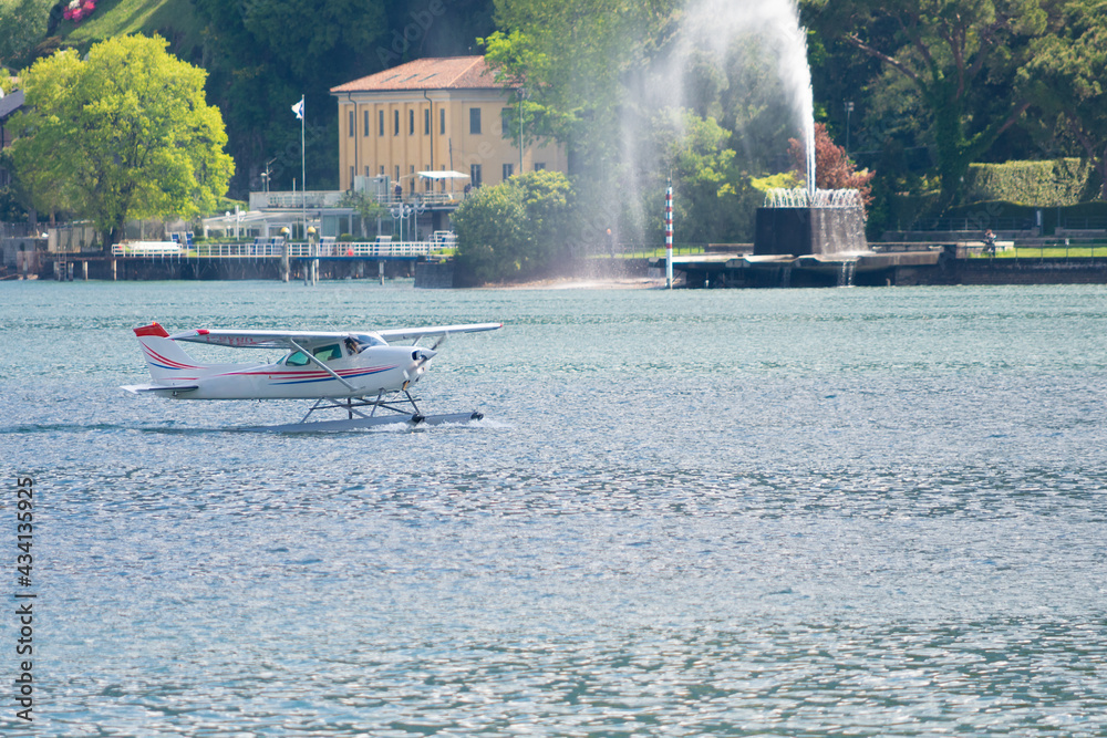 Obraz premium Take off of a seaplane over the waters of Lake Como, Como, Italy. This airplane take tourists for a tour of the entire lake. If you plan a travel in Como do not miss it.
