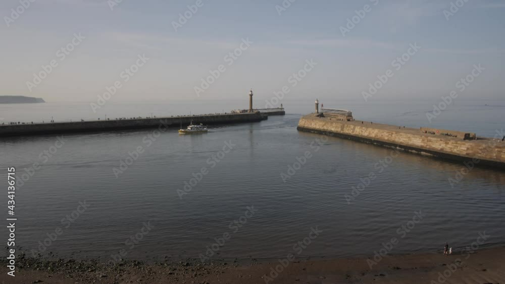 Boat entering harbour, Whitby, North Yorkshire, England, United Kingdom, Europe