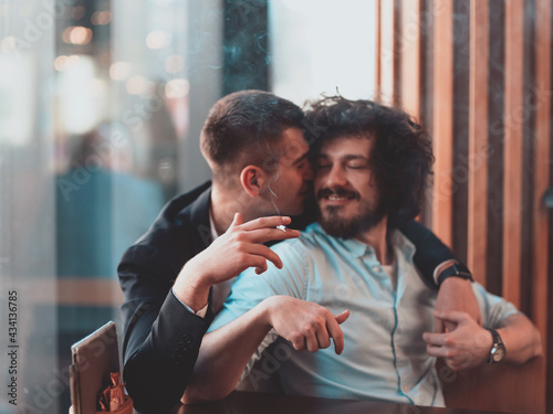 Portrait of multiethnic diverse gay LGBT romantic male couple embracing and showing their love