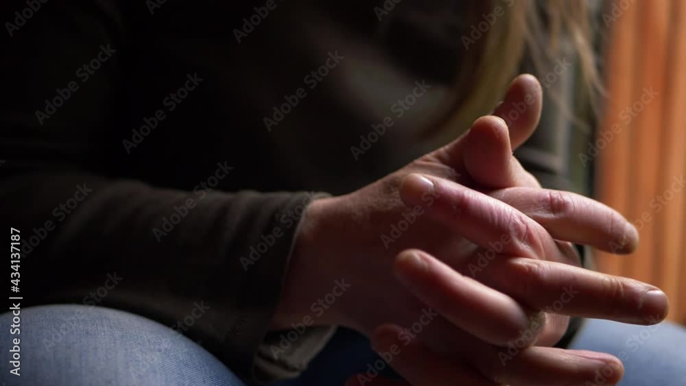 Anxious worried person rubbing hands