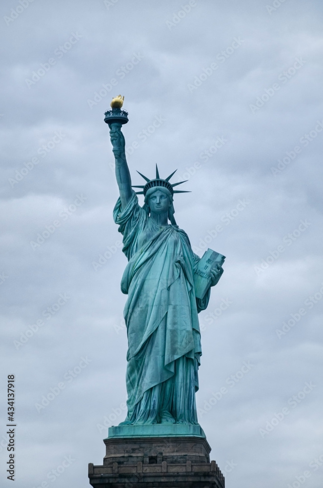 Fototapeta premium Statue of Liberty on the background of cloud sky.