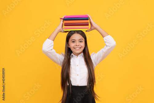 happy teen girl in school uniform hold book stack, knowledge