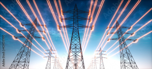 Foto Electricity transmission towers with glowing wires against blue sky - Energy con