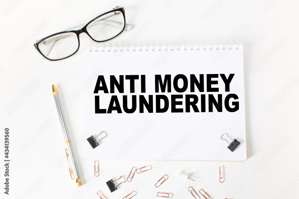 Notepad with text ANTI MONEY LAUNDERING on the office desk with stationery. A blank notepad for entering a copy or text. business Notepad with text ANTI MONEY LAUNDERING on the office desk with stationery. A blank notepad for entering a copy or text. business