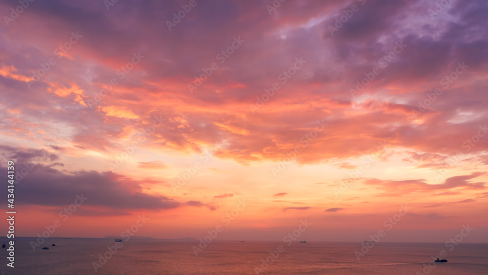 Areal view of seascape view and small container ship sailing in sea  at evening