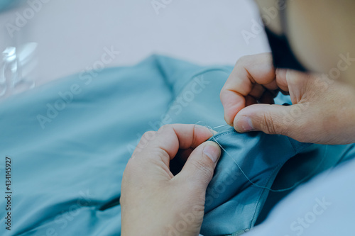 High angle shot of a worker sewing in a textile factory