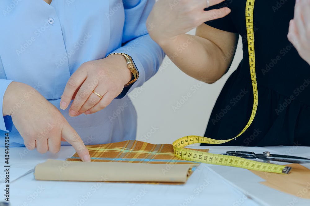 Obraz premium Women working with textile and fashion design sketches