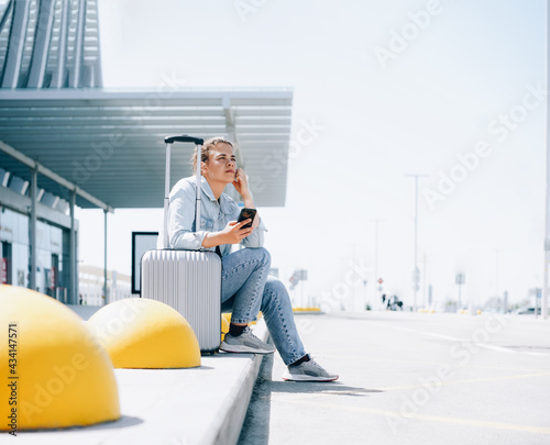 Young woman traveler at the station waiting for taxi