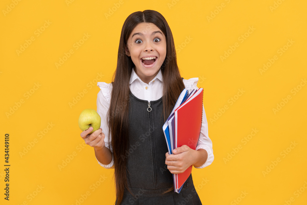 Learning by surprise. Surprised kid hold apple and books. Keep learning better Learning by surprise. Surprised kid hold apple and books. Keep learning better