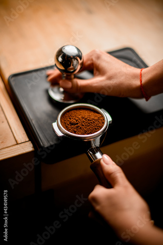 Εκτύπωση καμβά Close-up view of baristas hand tamping coffee in portafilter before making fresh