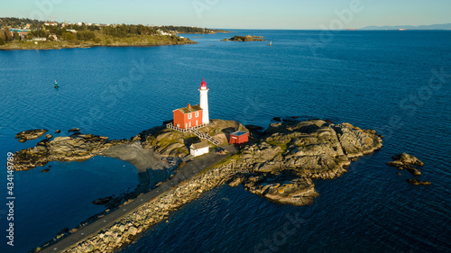 Aerial shot of the Fisgard Lighthouse surrounded by the sea in  Canada photo