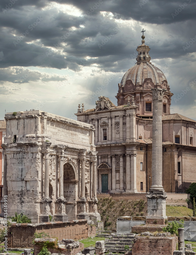 the arch of Tajan and baroque church in the Roman Forum, Rome, Italy