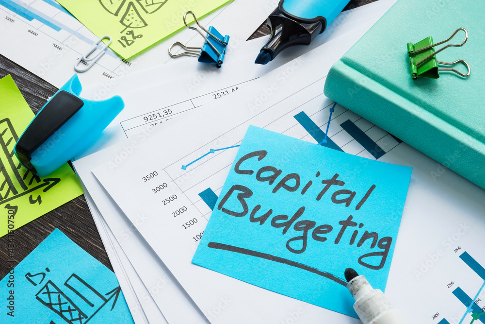 Papers with capital budgeting and business charts. Papers with capital budgeting and business charts.