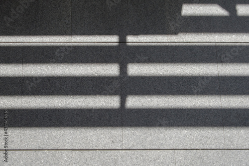 horizontal shadow on a stone wall of a building facade