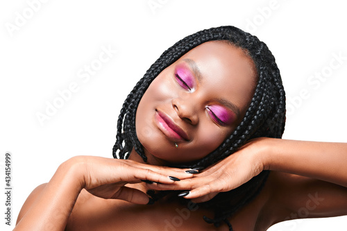 portrait with closed eyes african american girl. pink make-up visage. white background. isolate
