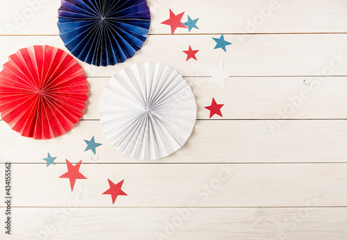 Decorations for 4th July  Independence Day USA. Paper fans and stars on white wooden background