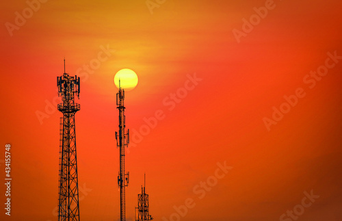 Silhouette telecommunications antenna for mobile phone at sunset