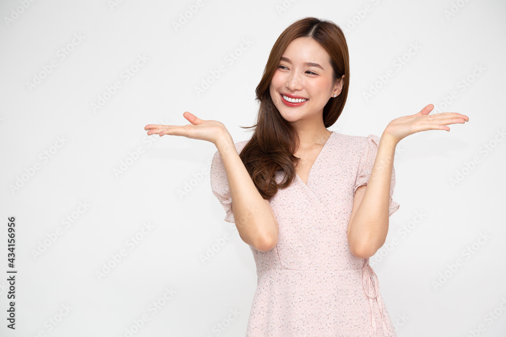 Happy Asian woman presenting or showing open hand palm with copy space for product isolated on white background Happy Asian woman presenting or showing open hand palm with copy space for product isolated on white background