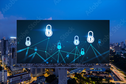 Photography Padlock icon hologram on road billboard over panorama city view of Kuala Lumpur at night to protect business, Malaysia, Asia