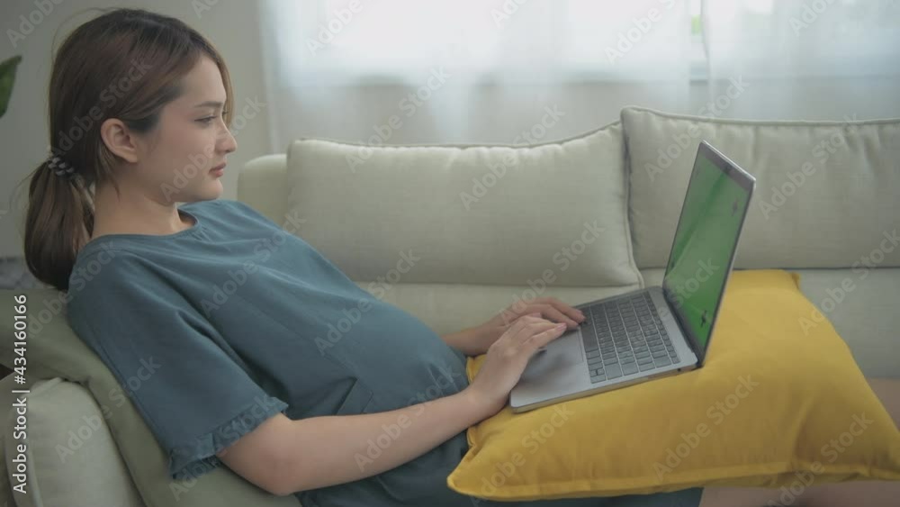 Pregnant woman concept of 4k Resolution. Asian girls are working using computers in the house. Pregnant woman concept of 4k Resolution. Asian girls are working using computers in the house.