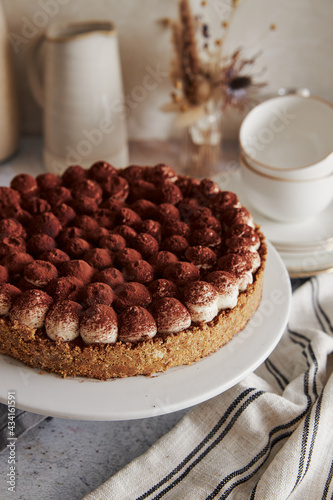 Vertical shot of a delicious Bonafi Cream Pie with chocolate powder on a beautifully decorated table photo