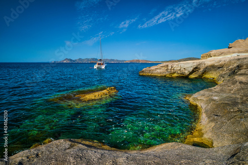 Yacht boat at Sarakiniko Beach in Aegean sea, Milos island , Greece photo