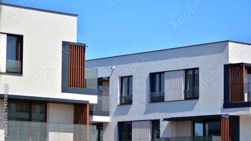 Condominium and apartment building with  symmetrical modern architecture. Detail in modern residential flat apartment building exterior. Fragment of new luxury house and home complex.  © Grand Warszawski