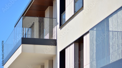 Condominium and apartment building with  symmetrical modern architecture. Detail in modern residential flat apartment building exterior. Fragment of new luxury house and home complex.  © Grand Warszawski