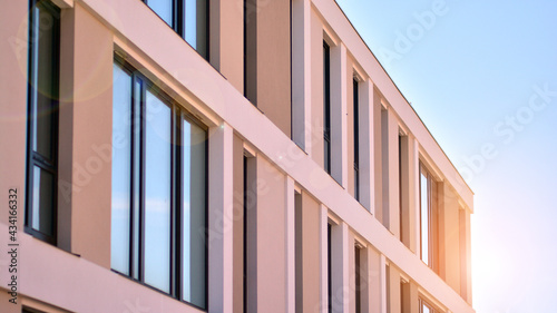 Apartment residential house and home facade architecture and outdoor facilities. Blue sky on the background. Sunlight in sunrise.