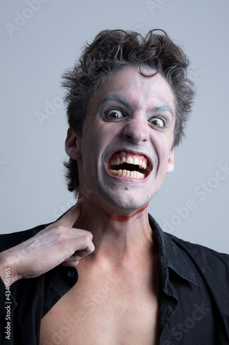 picture of a clown in a white studio imitating serious face