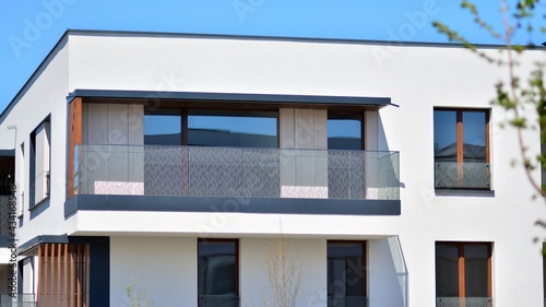 Condominium and apartment building with symmetrical modern architecture. Detail in modern residential flat apartment building exterior. Fragment of new luxury house and home complex. 